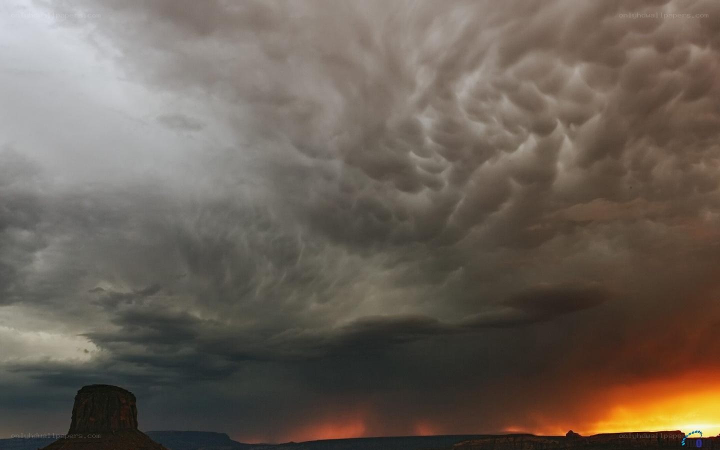 Storm clouds over desert butte