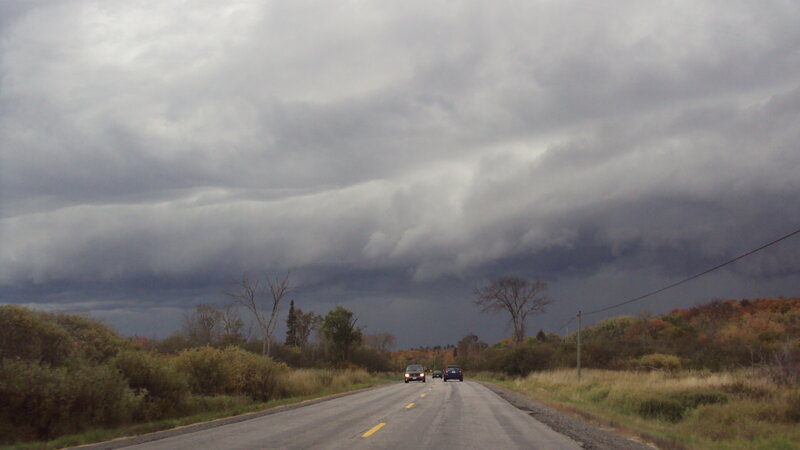 Storm clouds over rural road