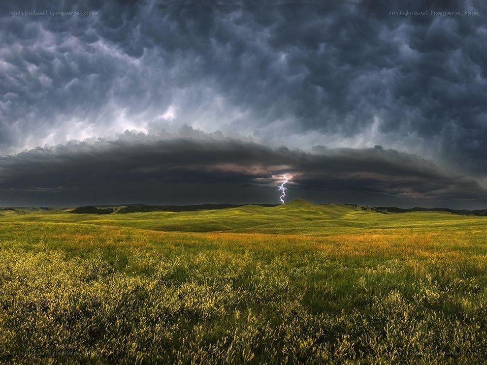Storm over a green field