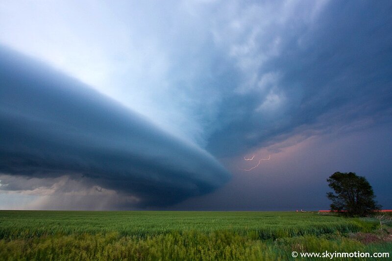 Storm over a green field
