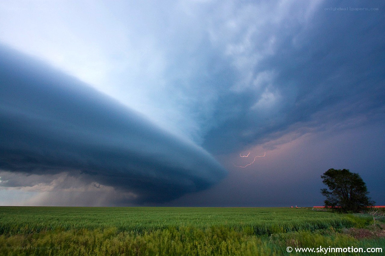 Storm over a green field