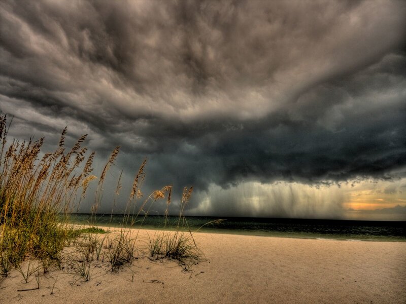 Storm over beach at sunset
