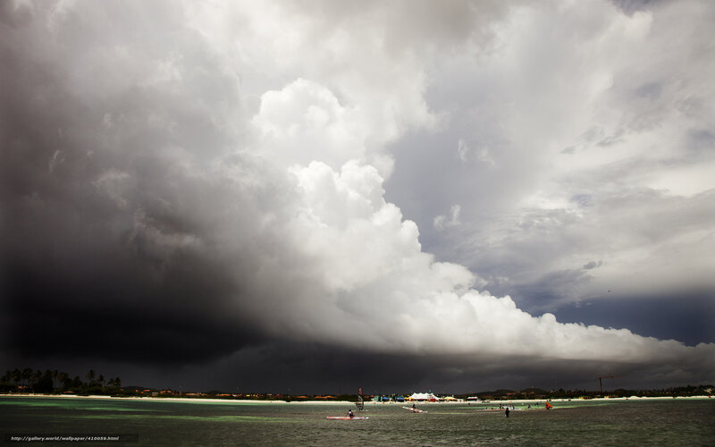 Storm over beach with windsurfers