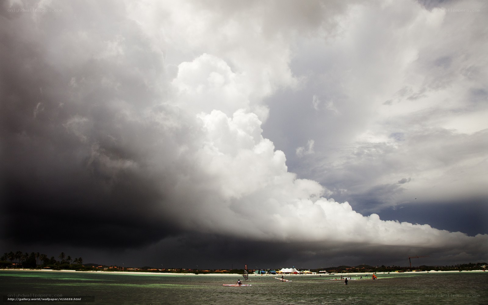 Storm over beach with windsurfers