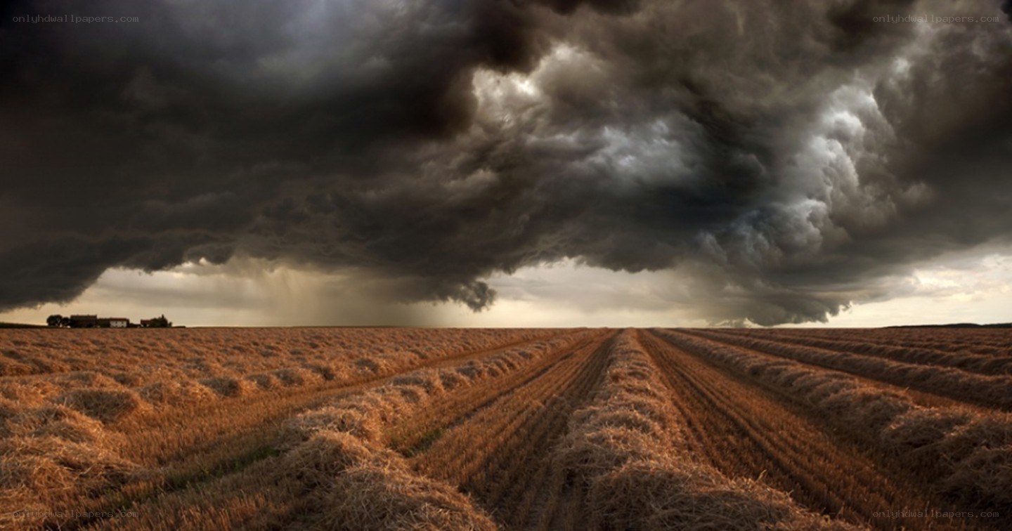 Storm over harvested field