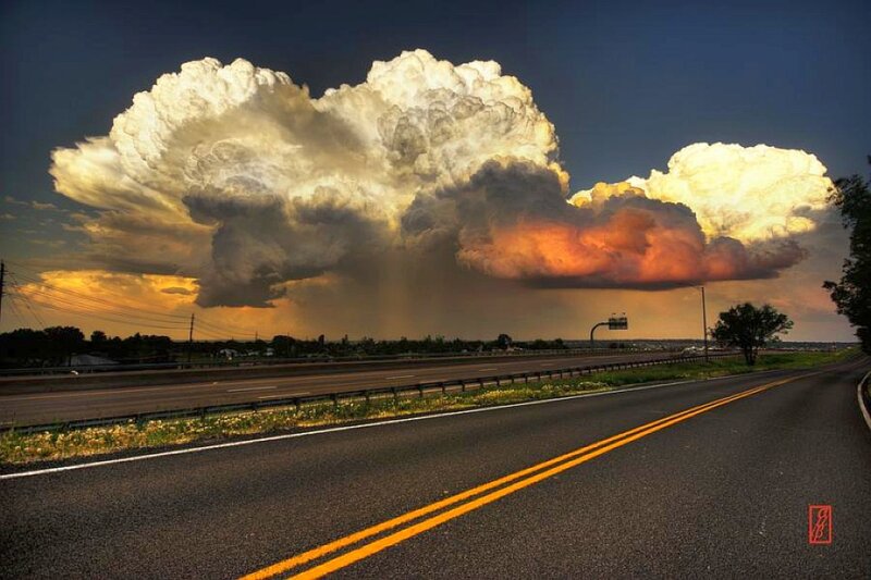 Storm over highway at sunset