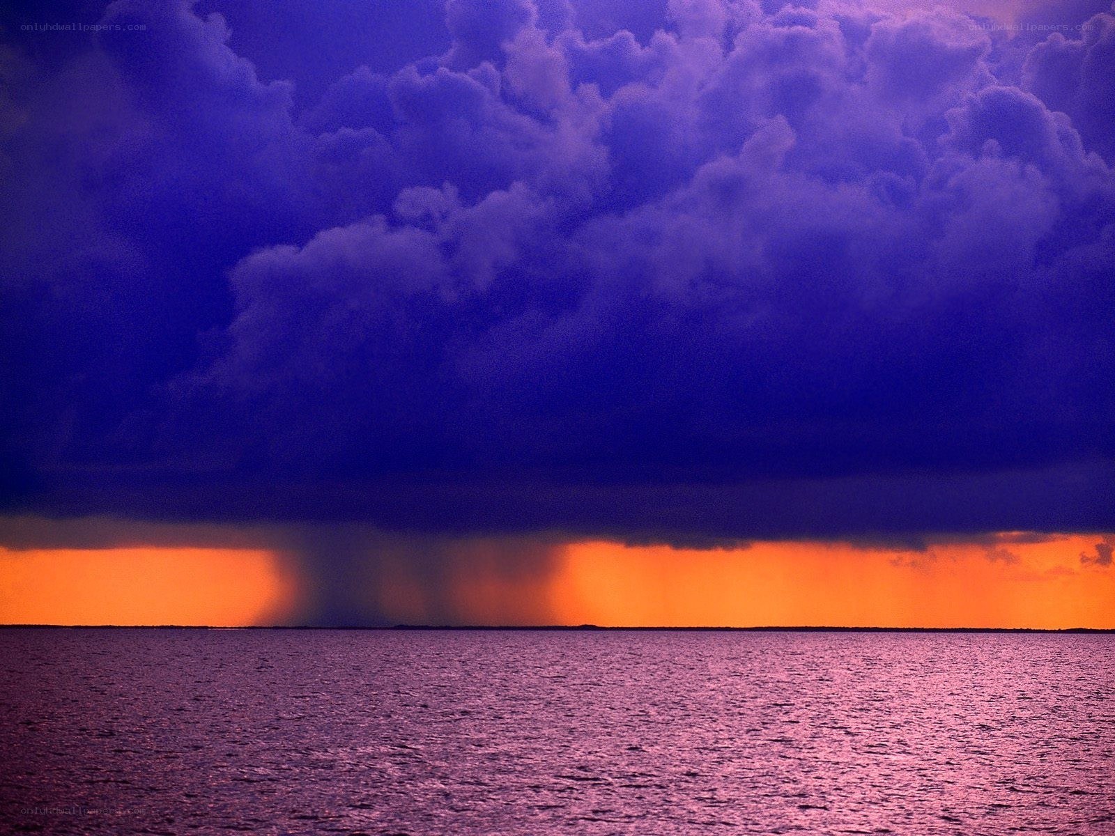 Storm over the ocean at sunset