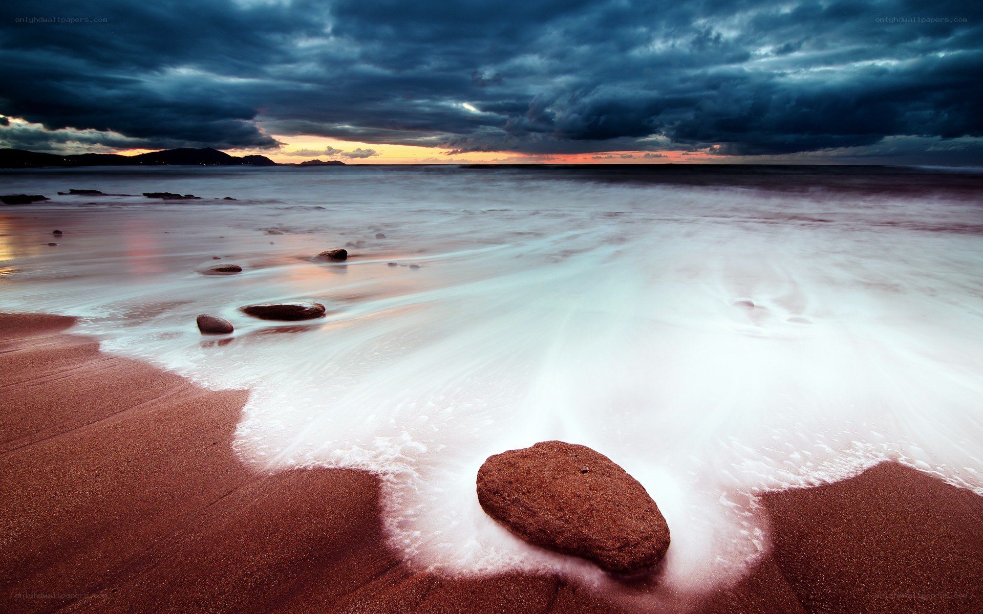Stormy beach at sunset