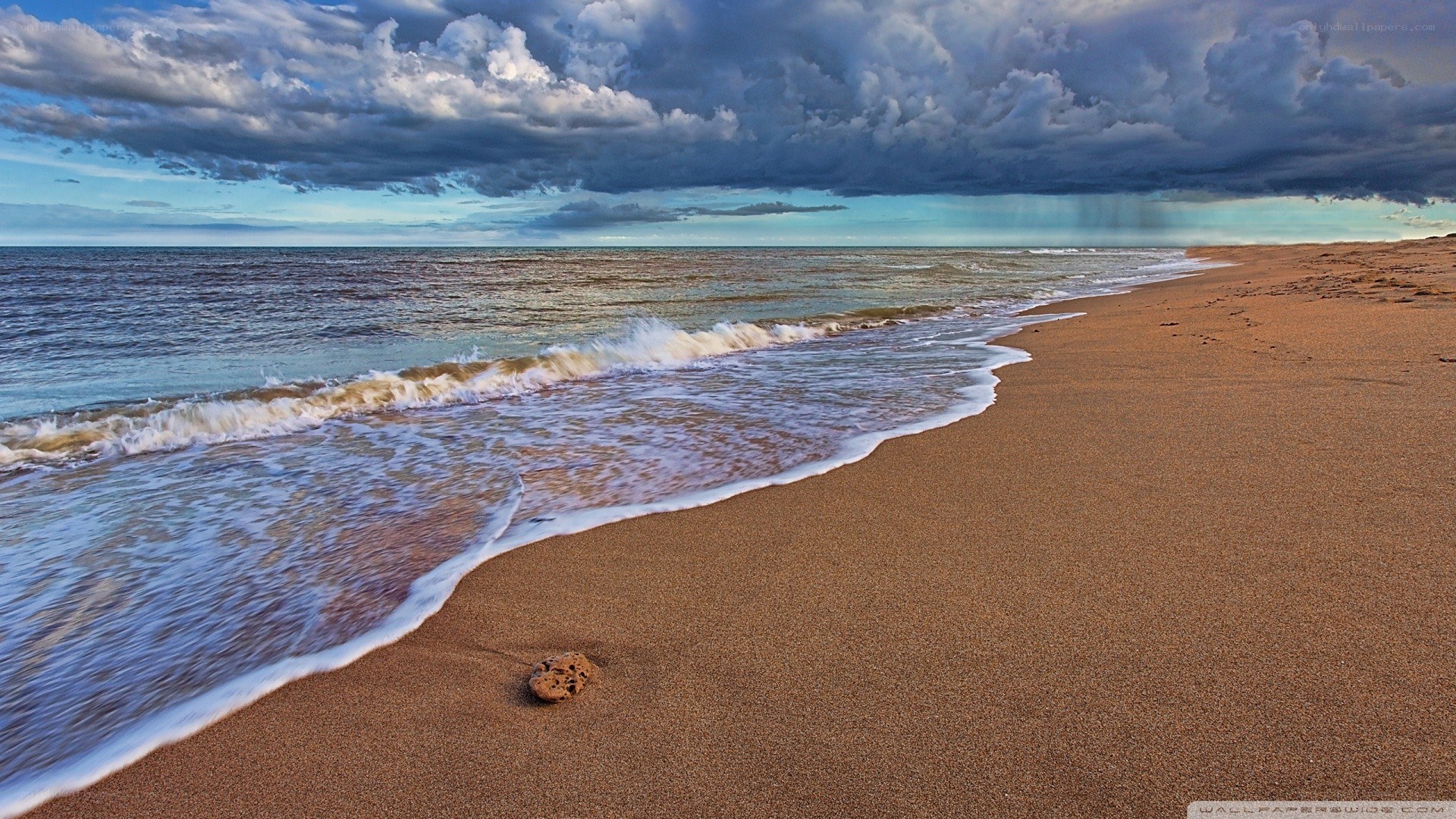 Stormy beach at sunset