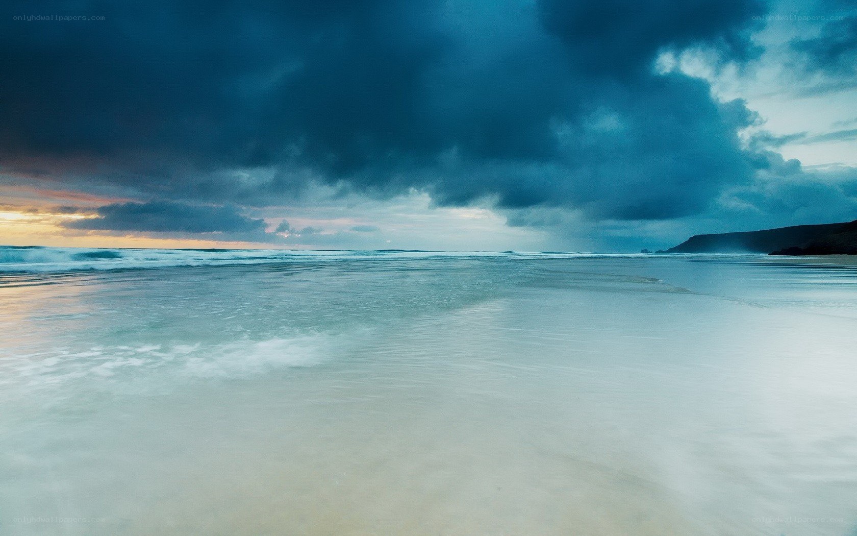 Stormy beach at sunset