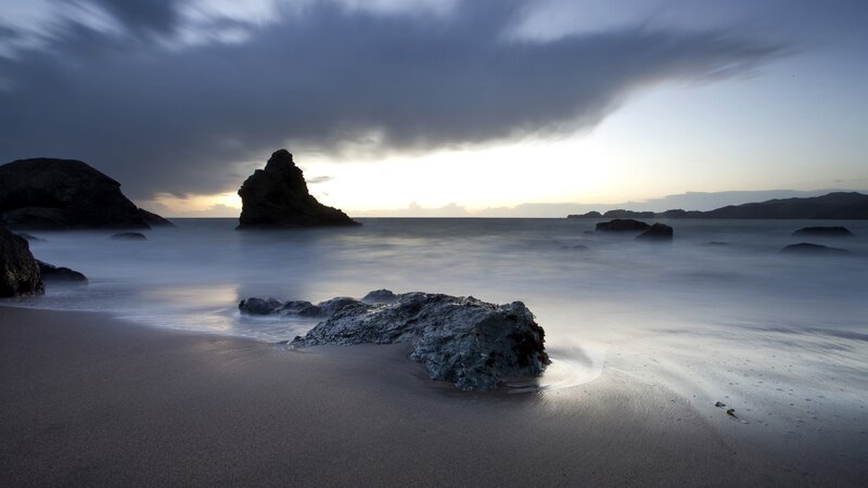 Stormy beach at sunset