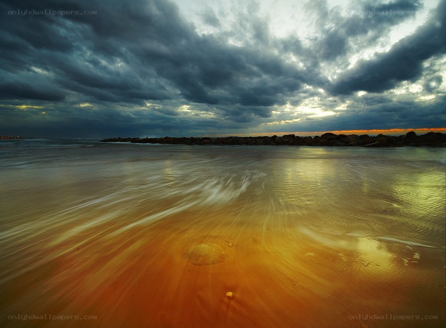 Stormy beach at sunset