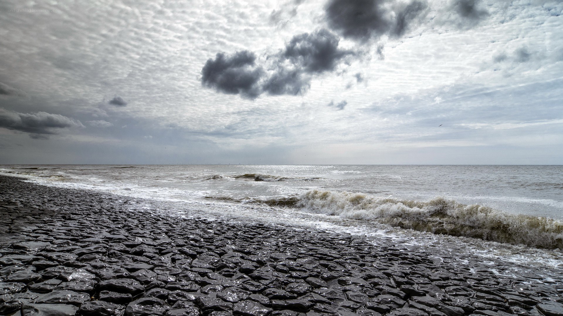 Stormy beach with cobblestones