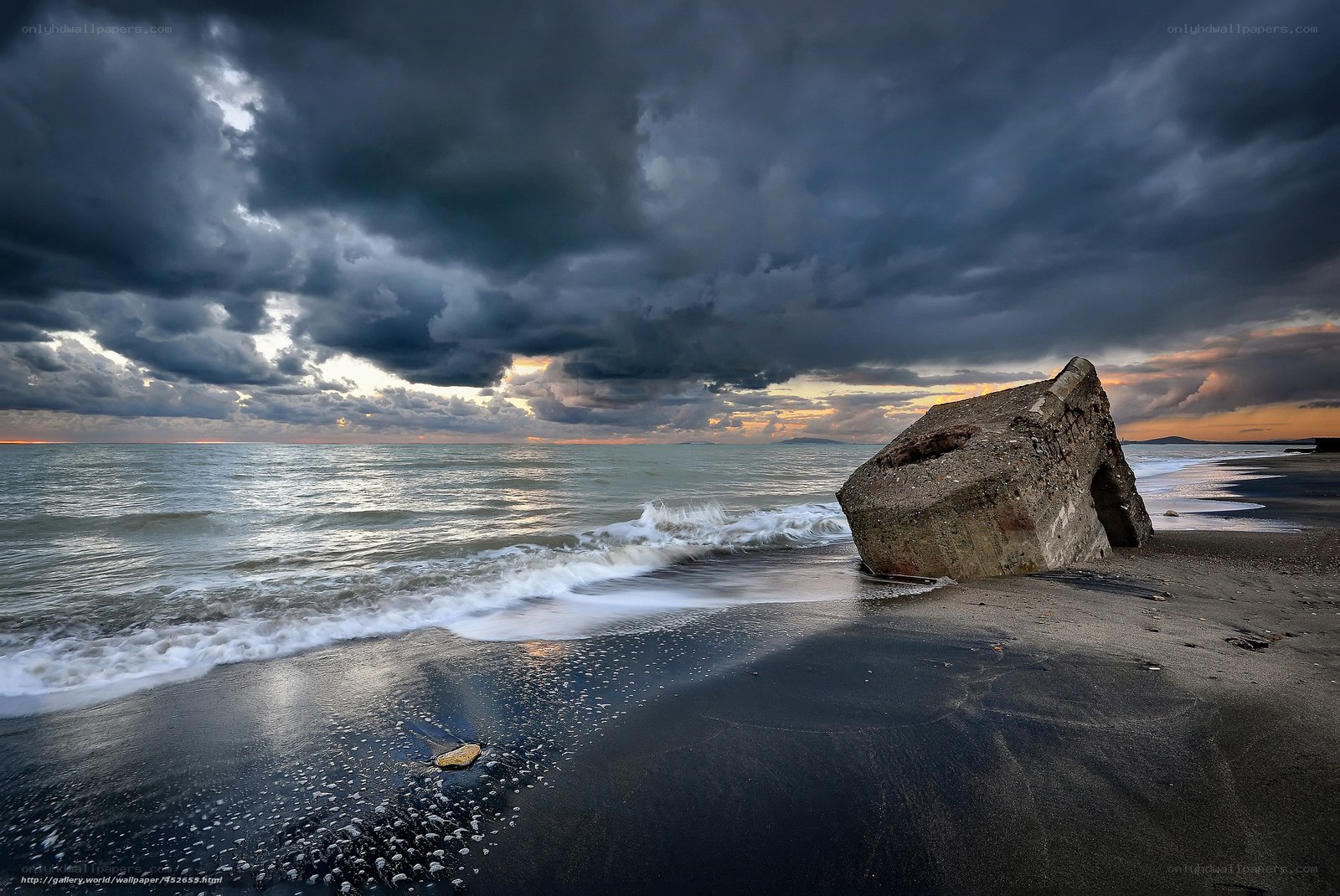 Stormy beach with concrete ruin