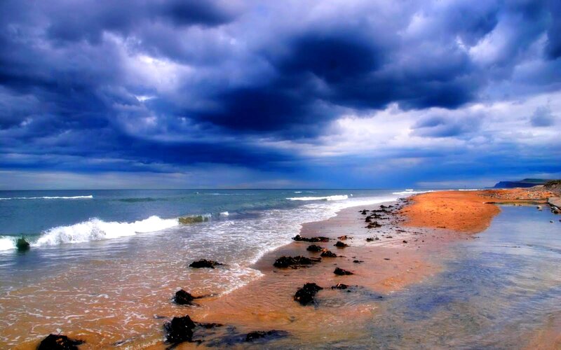 Stormy beach with dark clouds