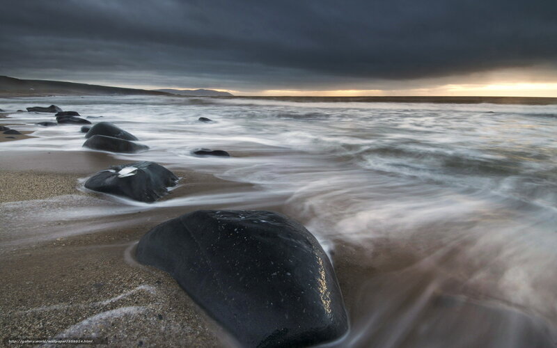 Stormy beach with dark rocks