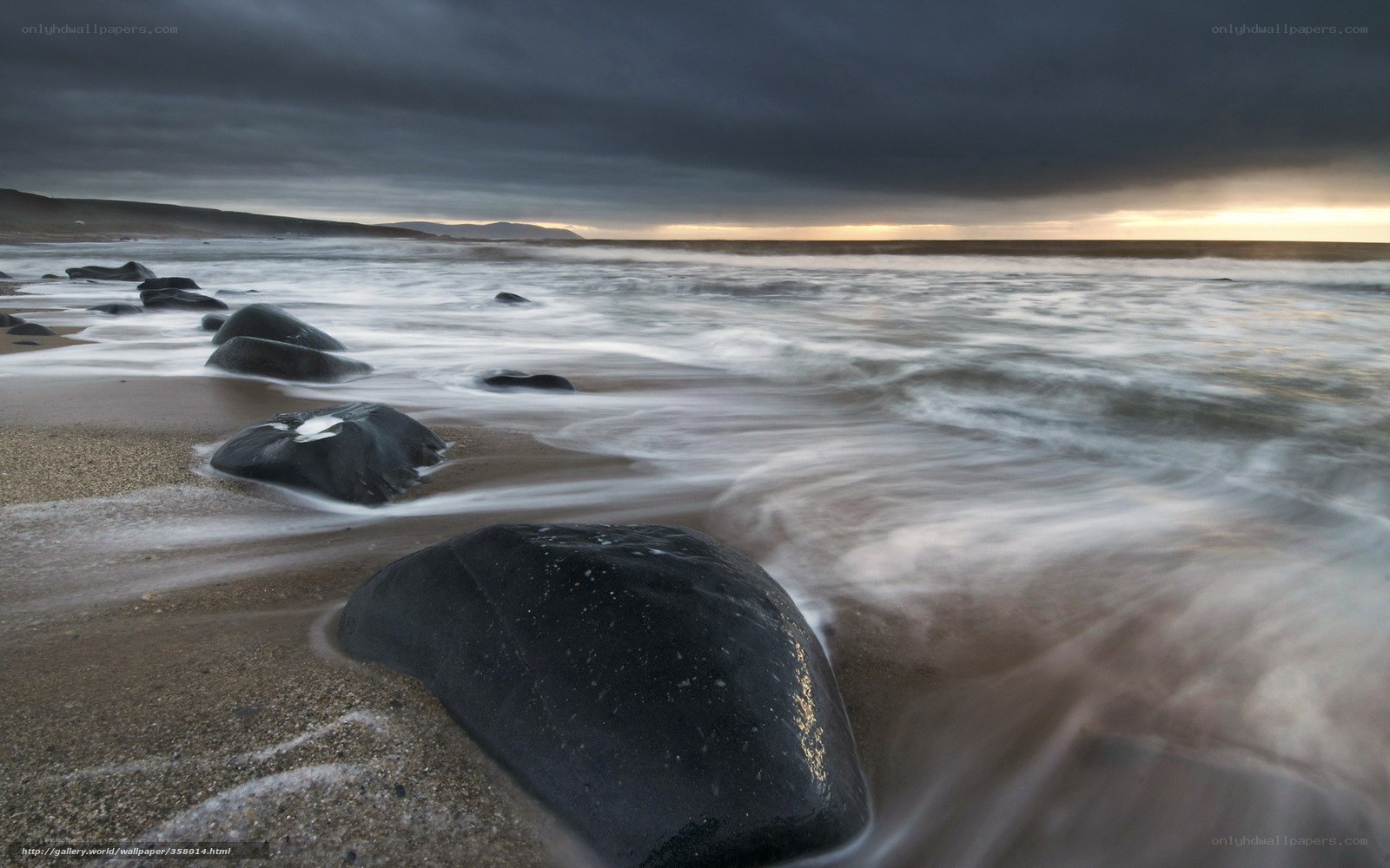 Stormy beach with dark rocks