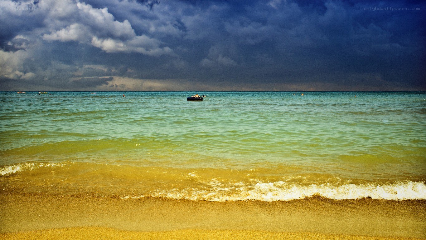 Stormy beach with inflatable boat
