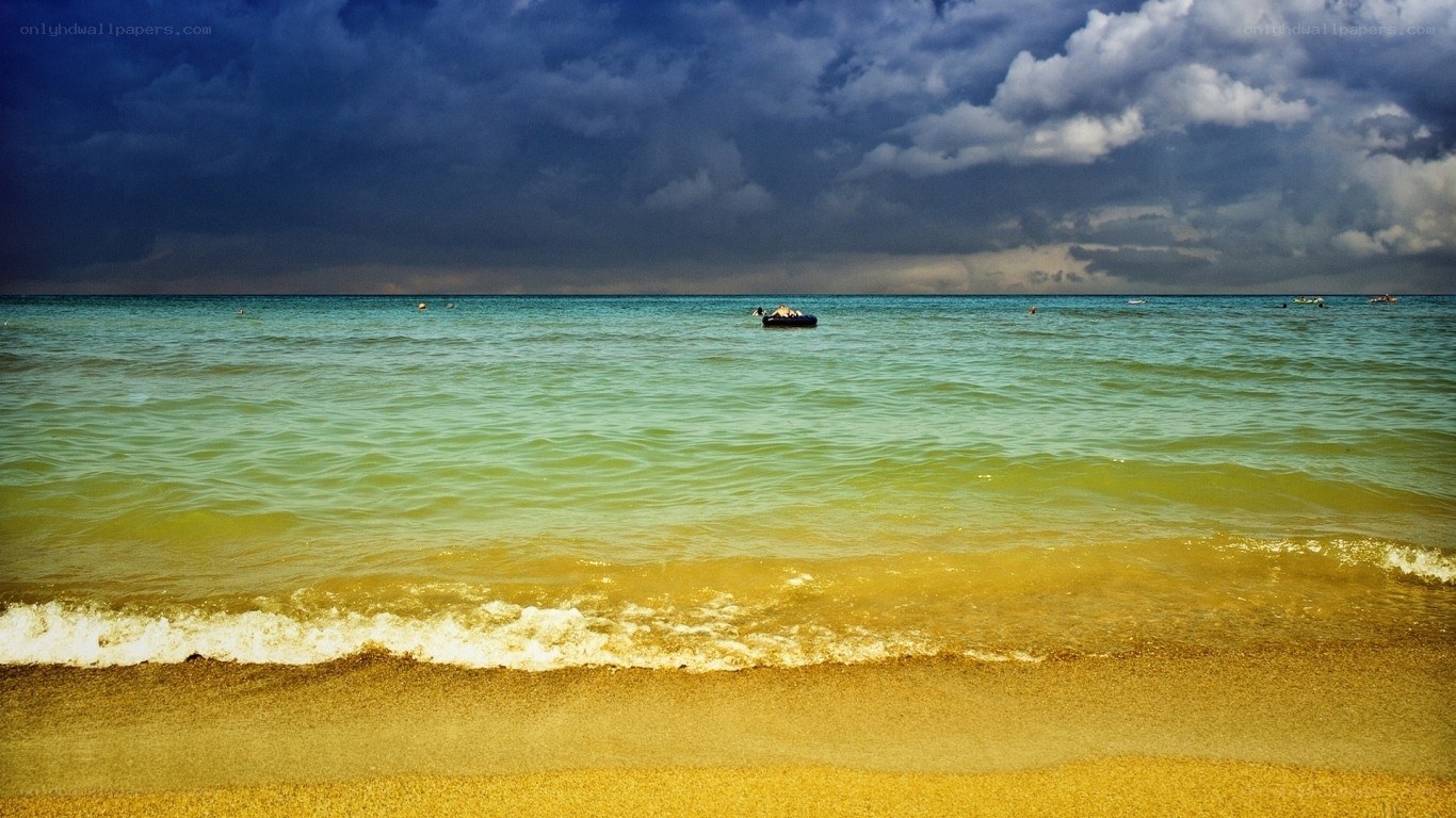 Stormy beach with inflatable boat