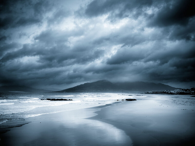 Stormy Beach with Mountains — Blue