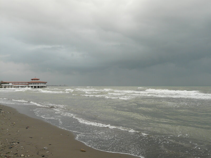Stormy beach with pier
