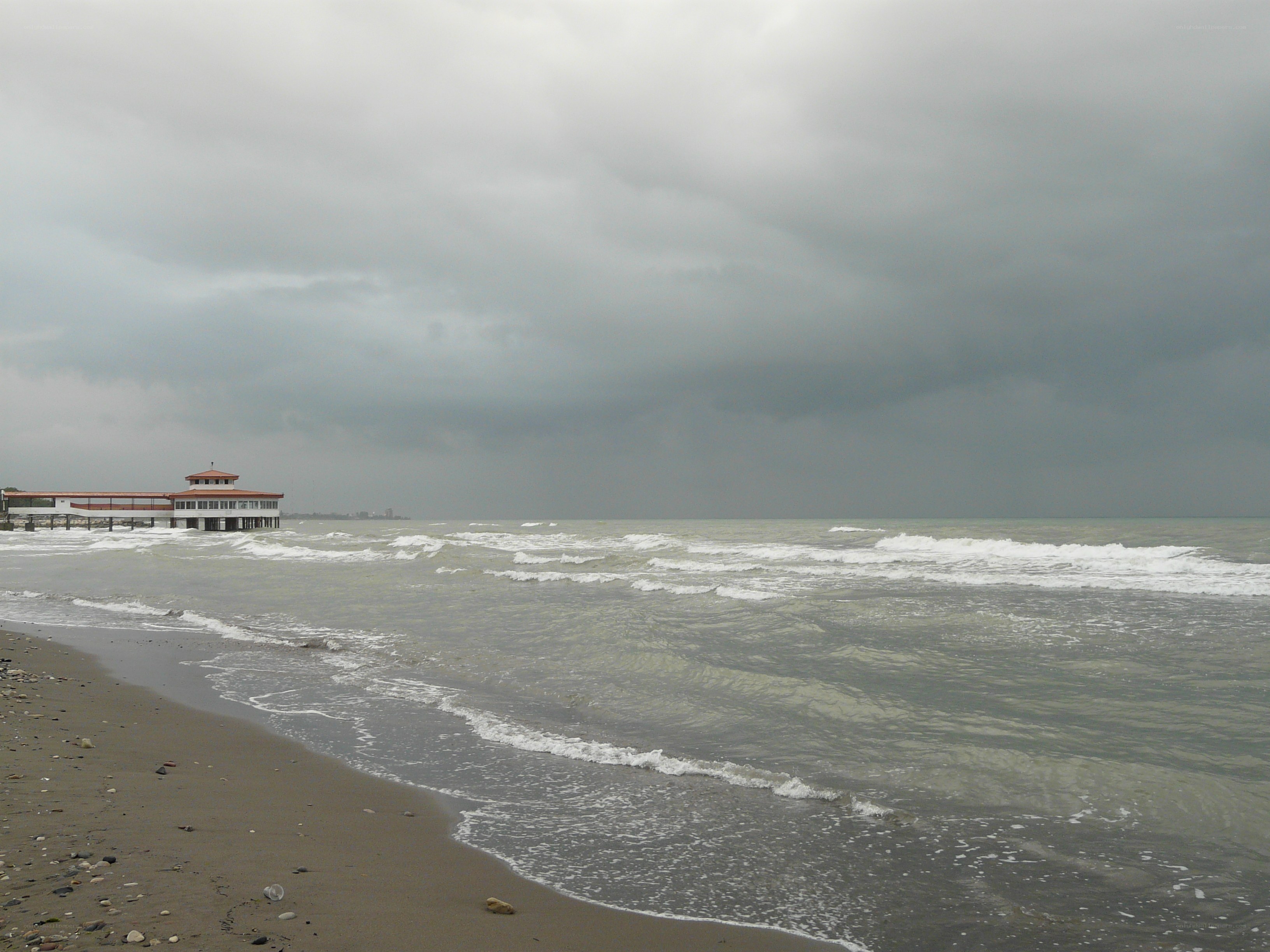 Stormy beach with pier