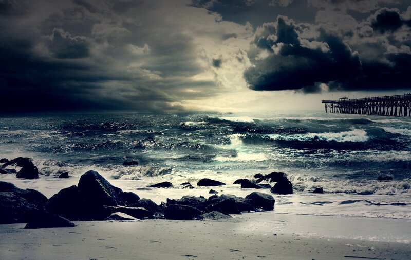 Stormy beach with pier