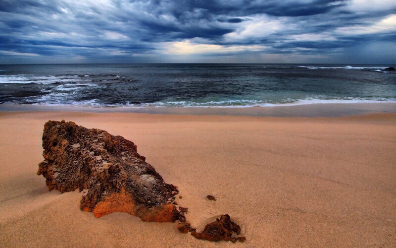 Stormy beach with rock