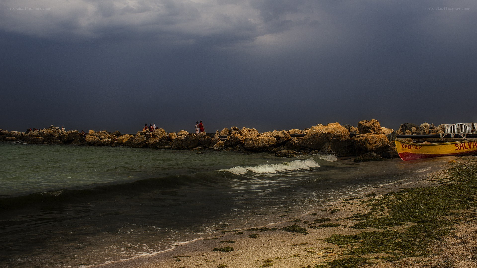 Stormy beach with rocky jetty