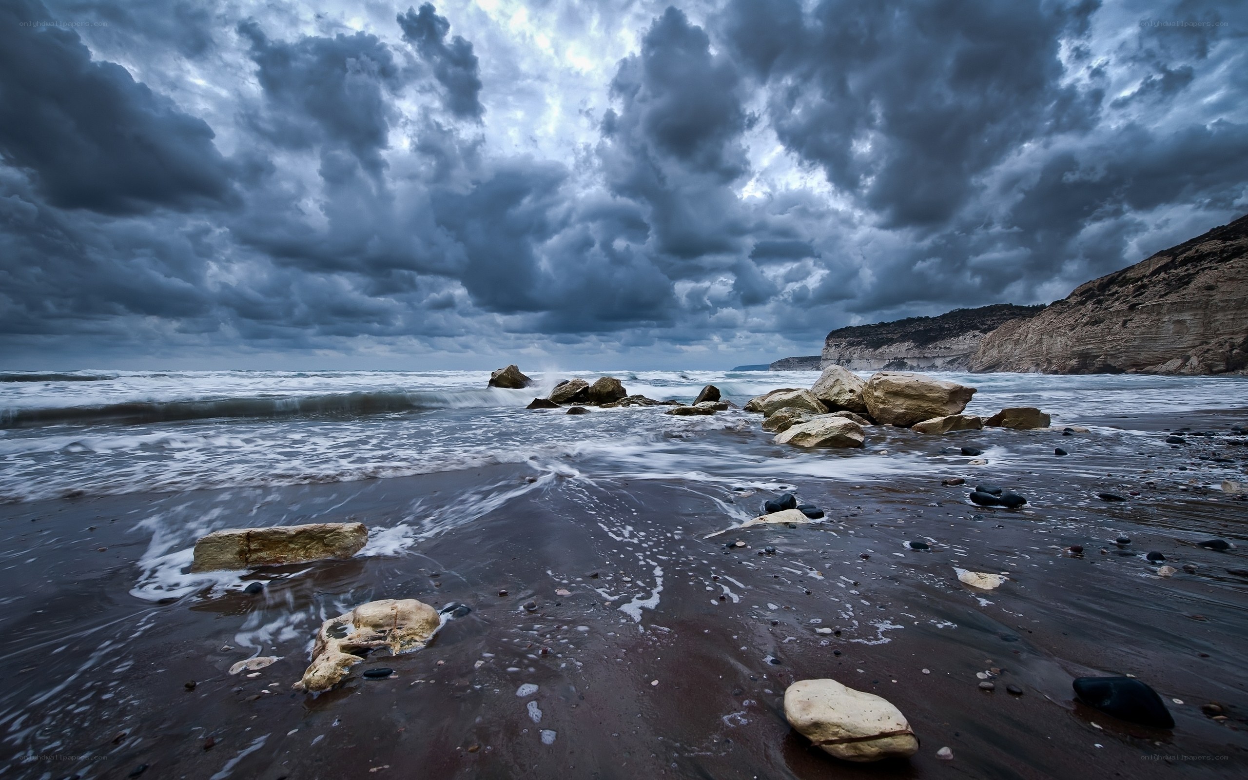Stormy beach with rocky shore
