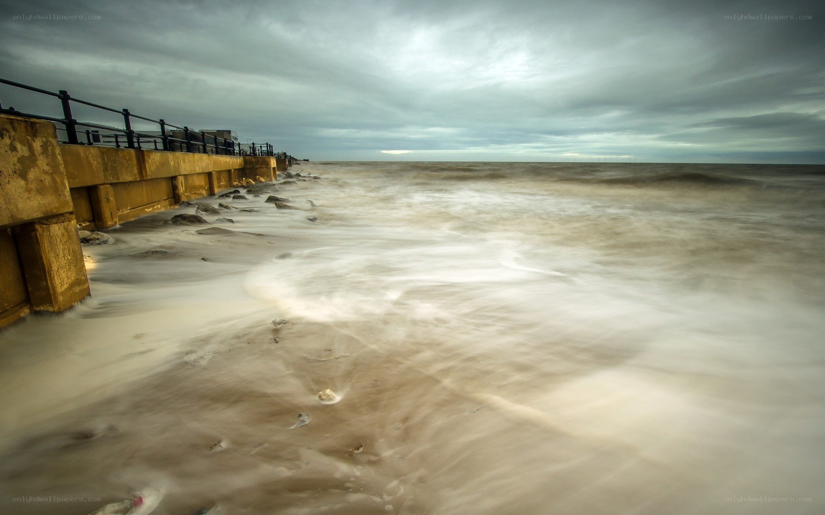 Stormy beach with sea wall