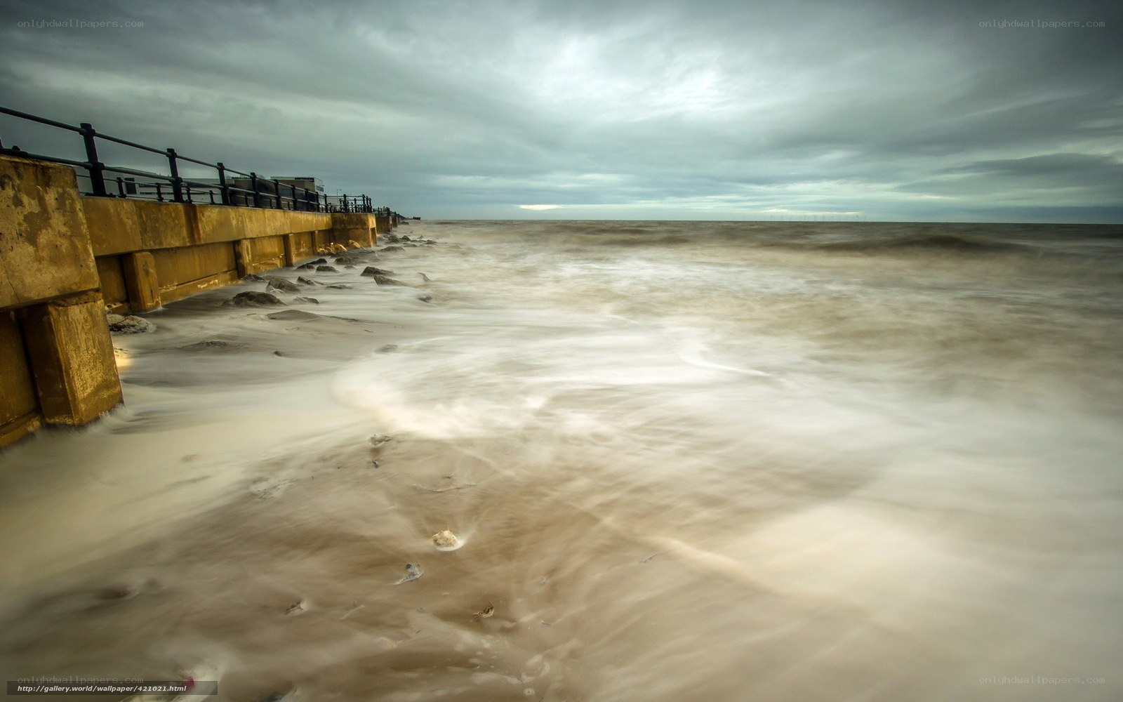 Stormy beach with sea wall