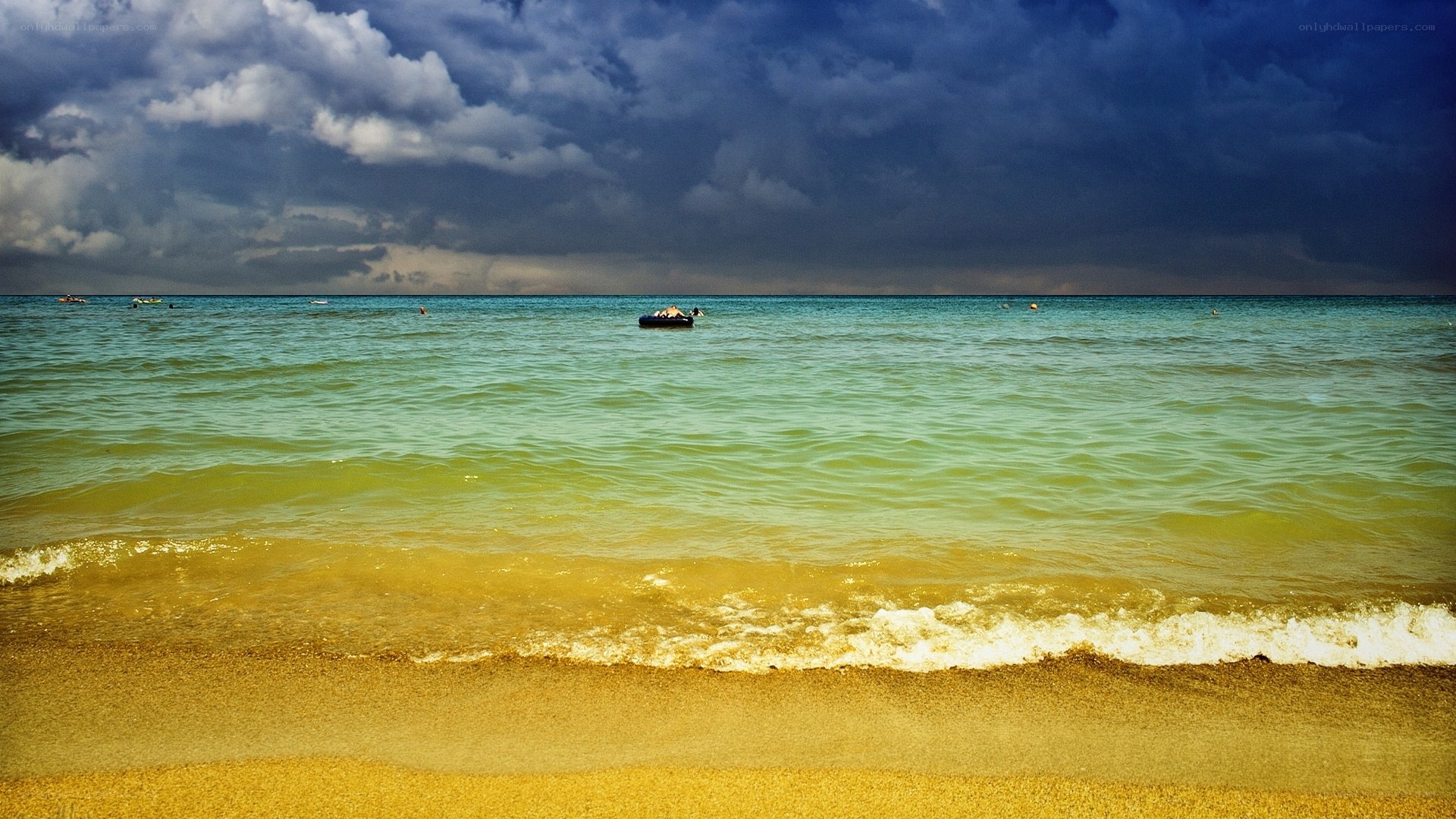 Stormy beach with small boat