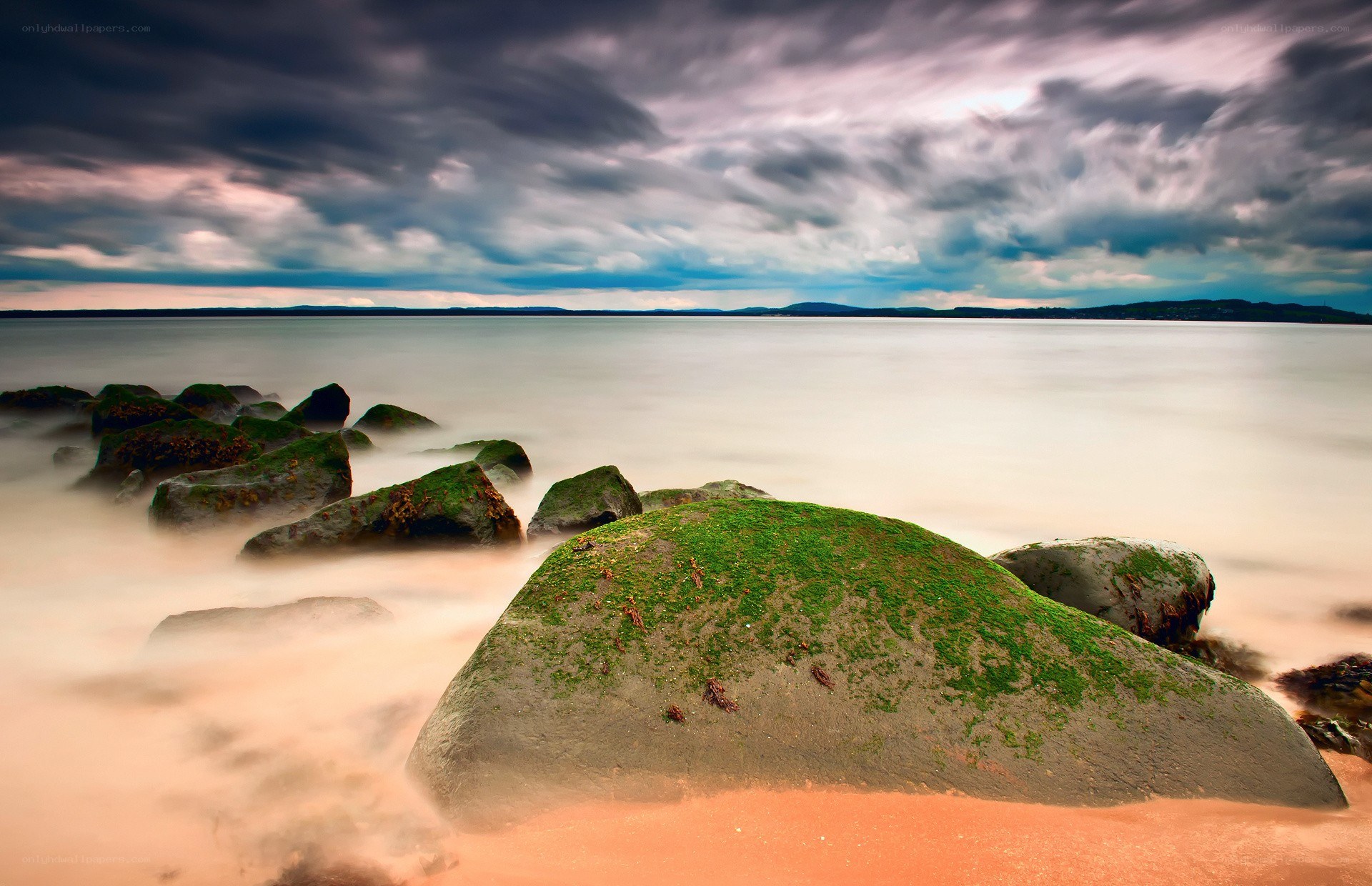 Stormy coast with moss-covered rocks