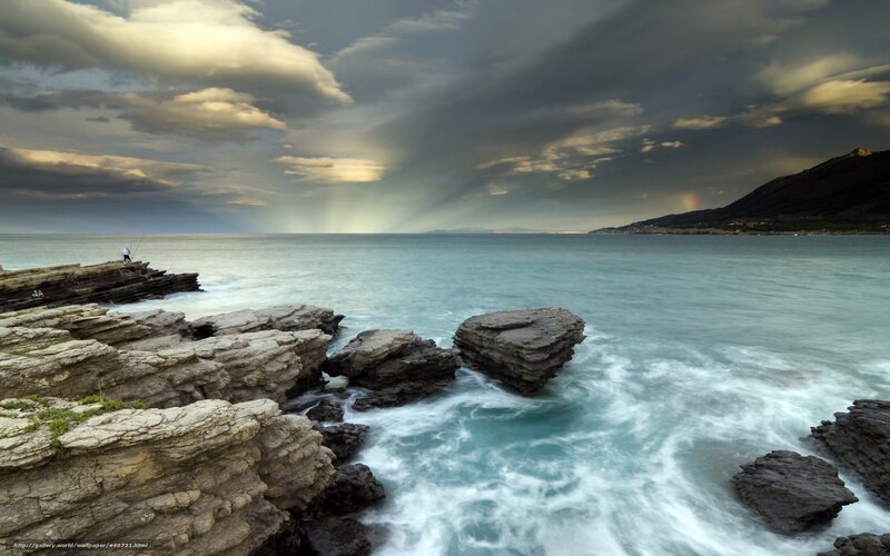 Stormy coast with rainbow