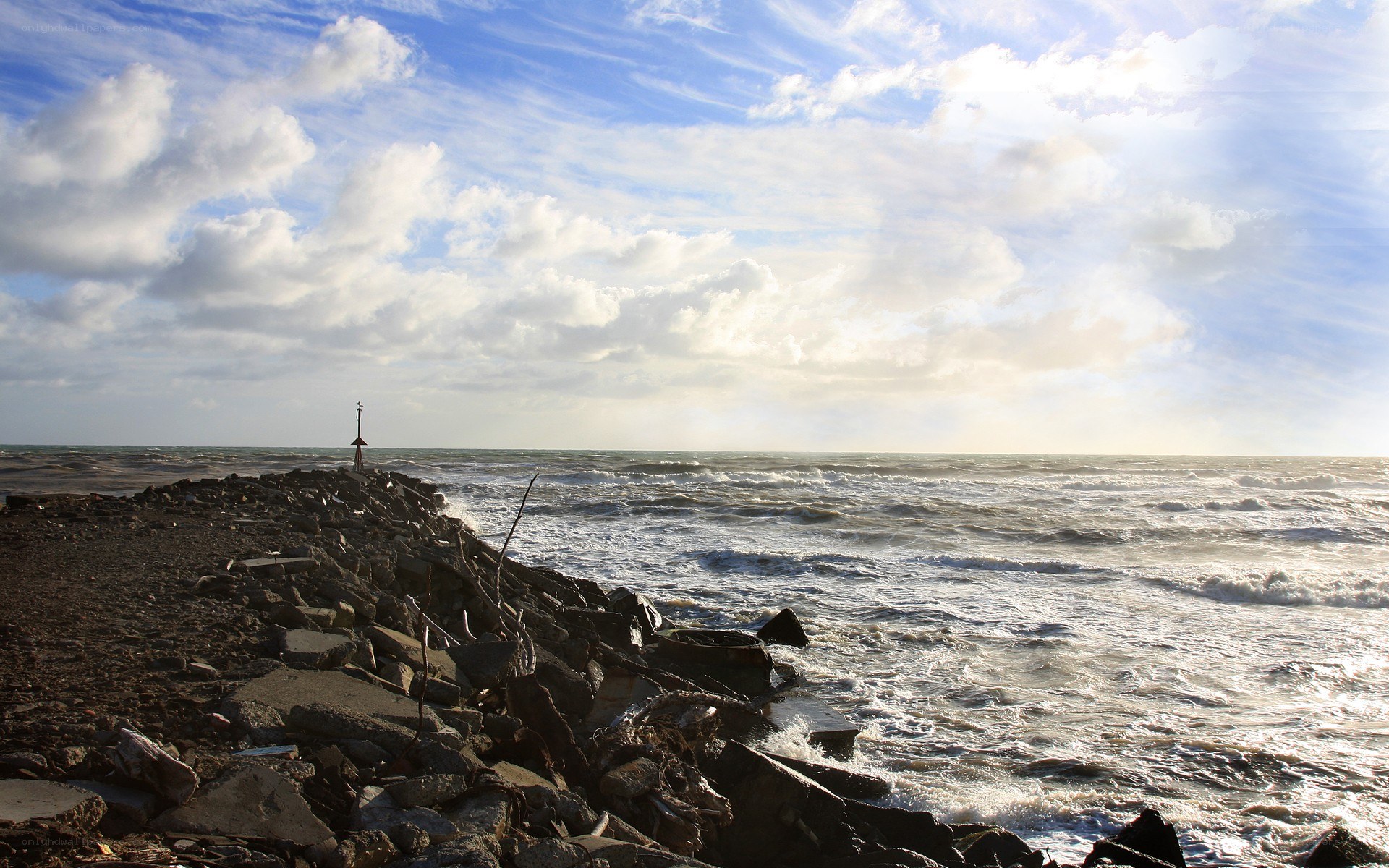 Stormy coast with rocky jetty