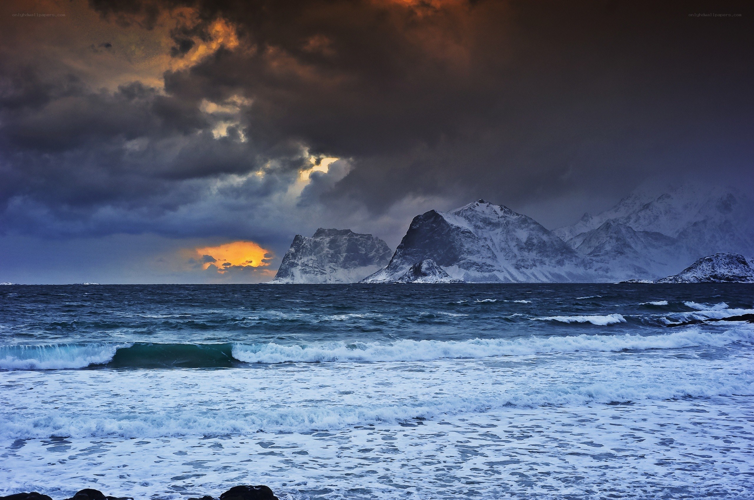 Stormy coast with snow-capped mountains