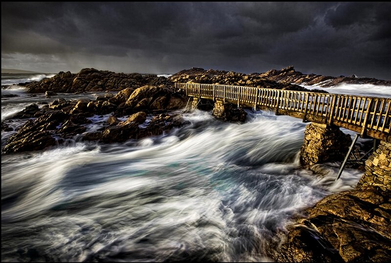 Stormy coastal bridge scene