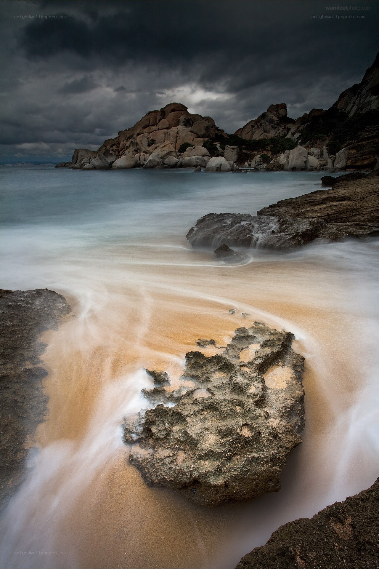 Stormy coastal rocks and sand
