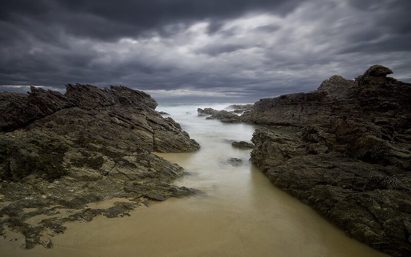 Stormy coastal rocks and tide