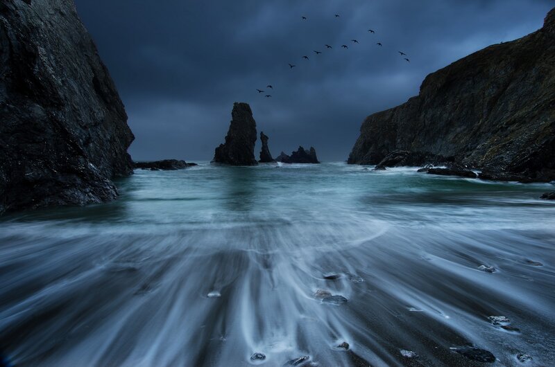 Stormy coastal rocks at dusk