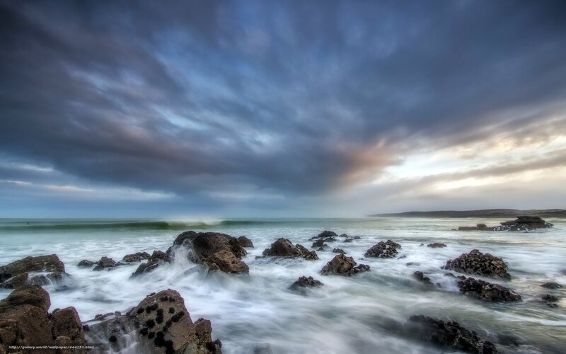 Stormy coastal rocks at dusk