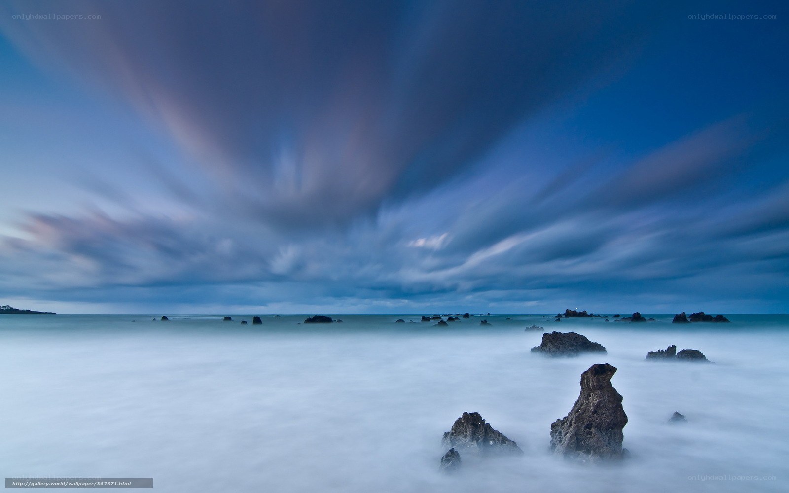 Stormy coastal rocks at dusk
