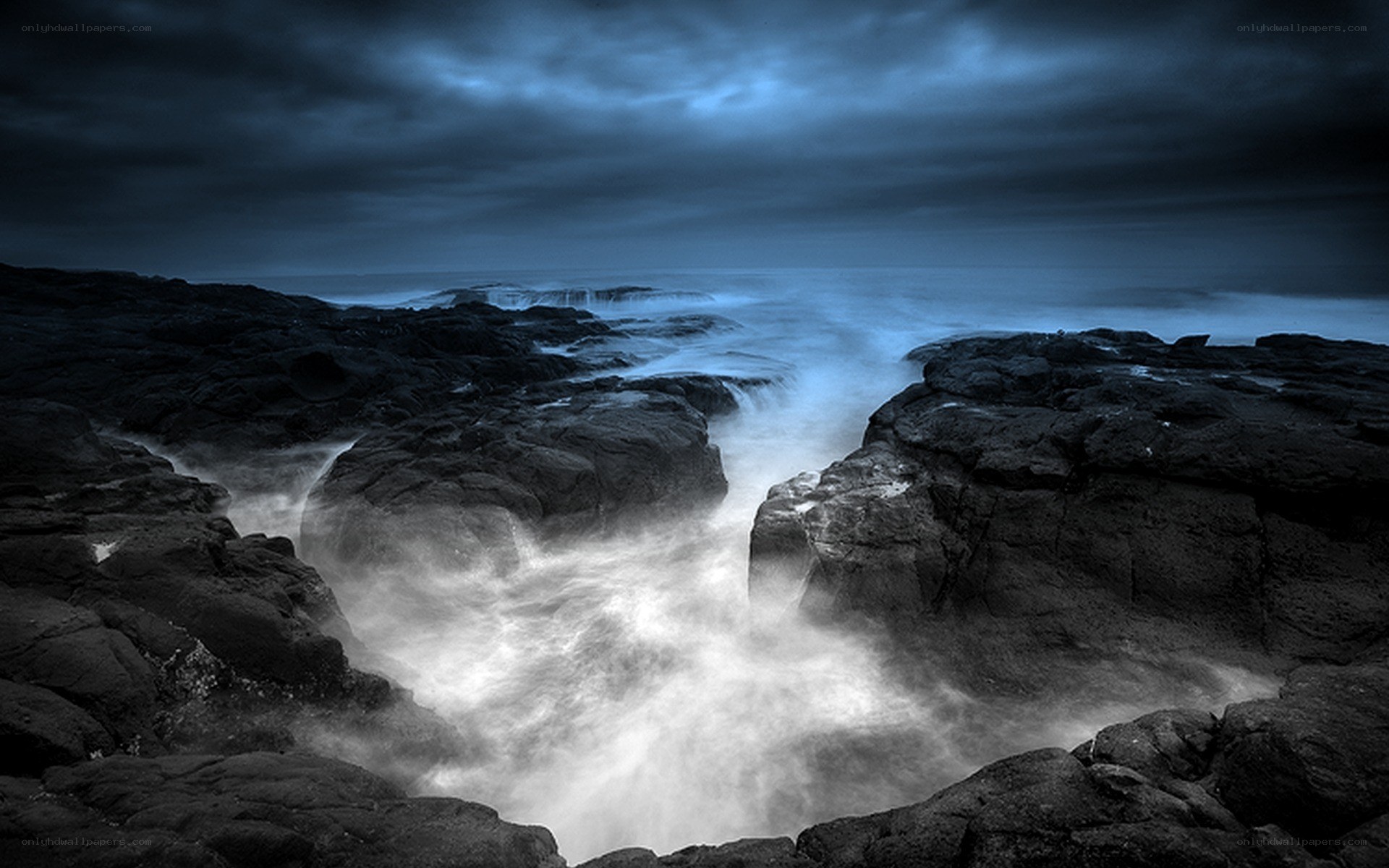 Stormy coastal rocks at night