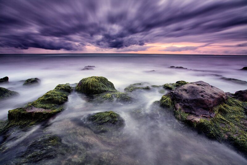 Stormy coastal rocks at sunset