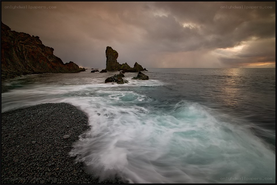 Stormy coastal rocks at sunset