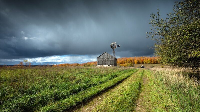 Stormy farm with windmill