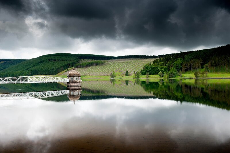 Stormy lake with dam tower