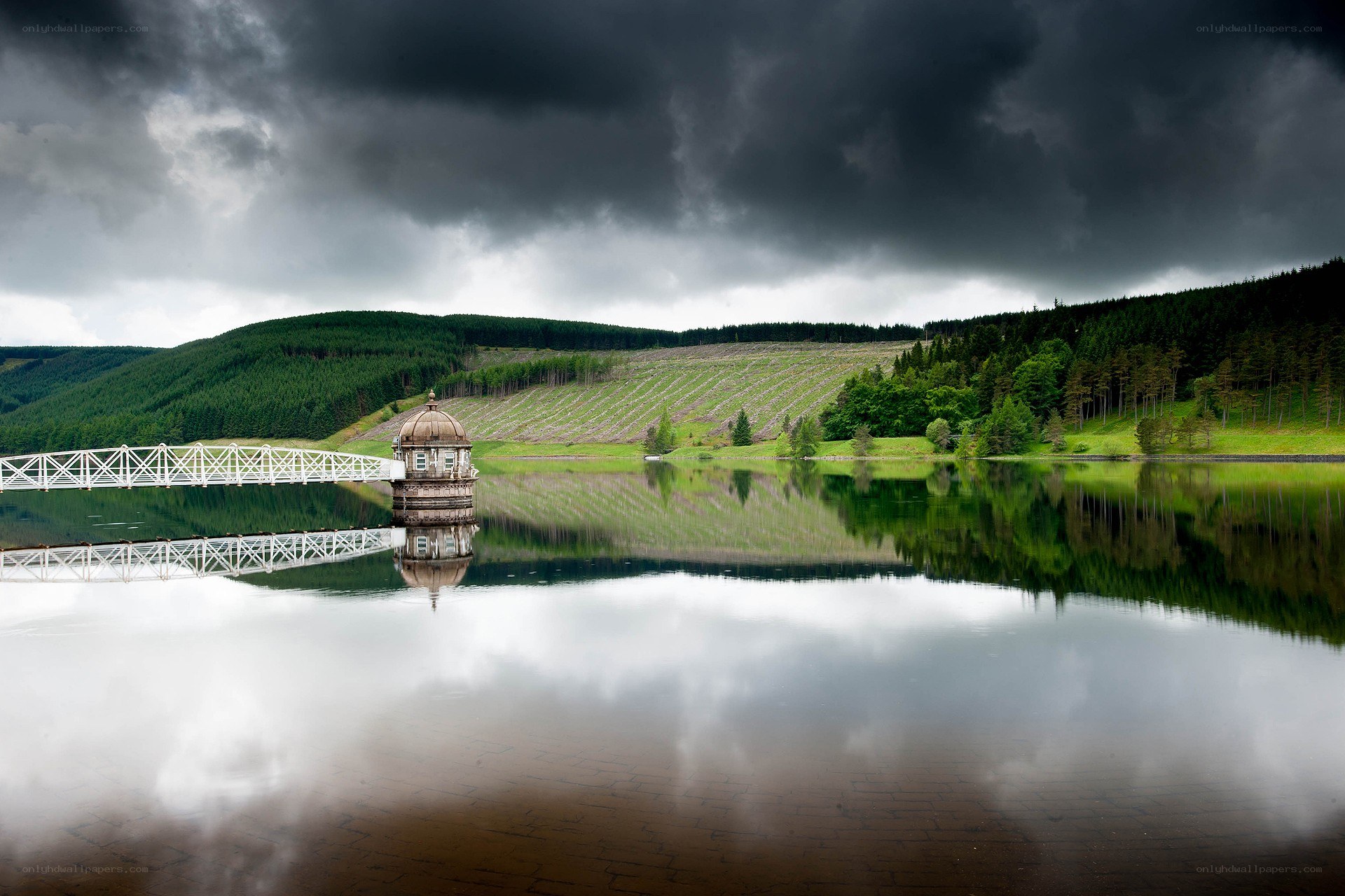 Stormy lake with dam tower