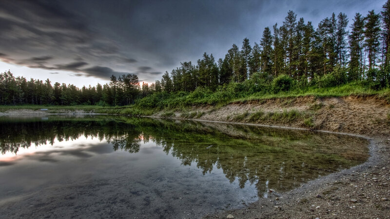 Stormy lake with forest reflection